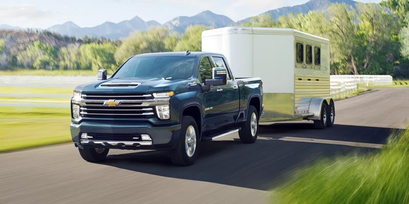 chevy truck towing horse trailer on road